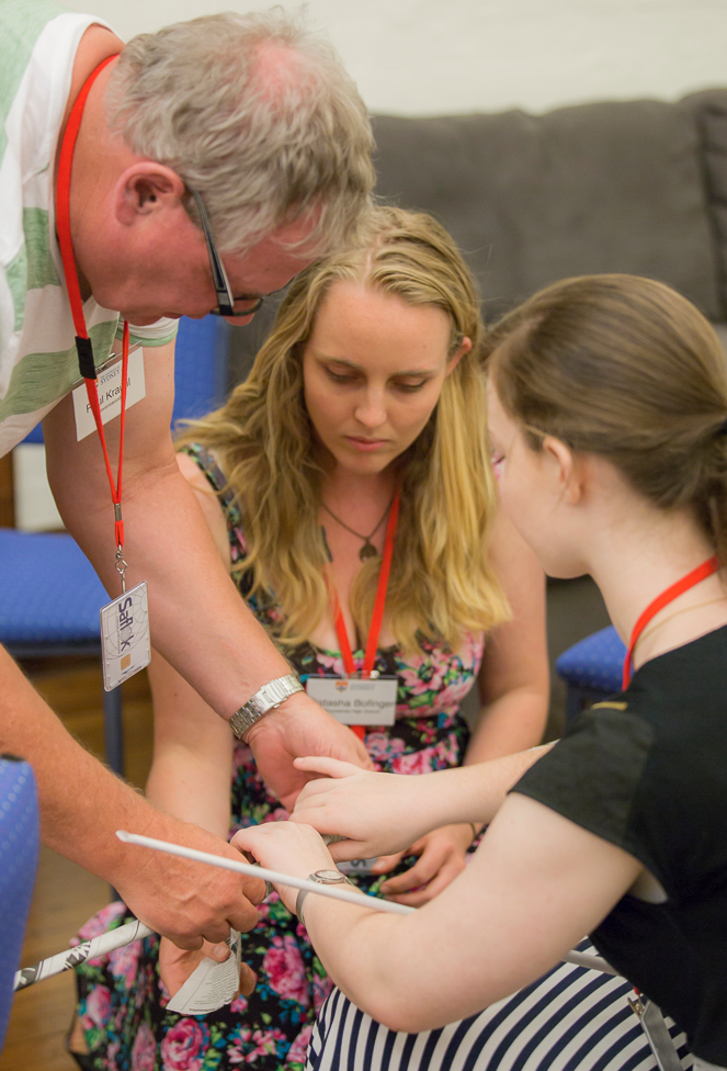 Three people taking part in a STEM academy experiment