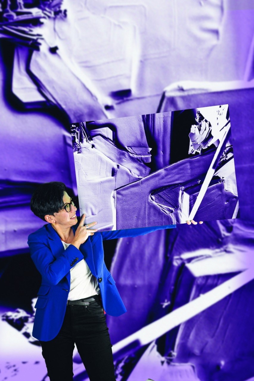 Chiara Neto standing amid what looks likes vibrant purple bed sheets glued to the surrounding surfaces.