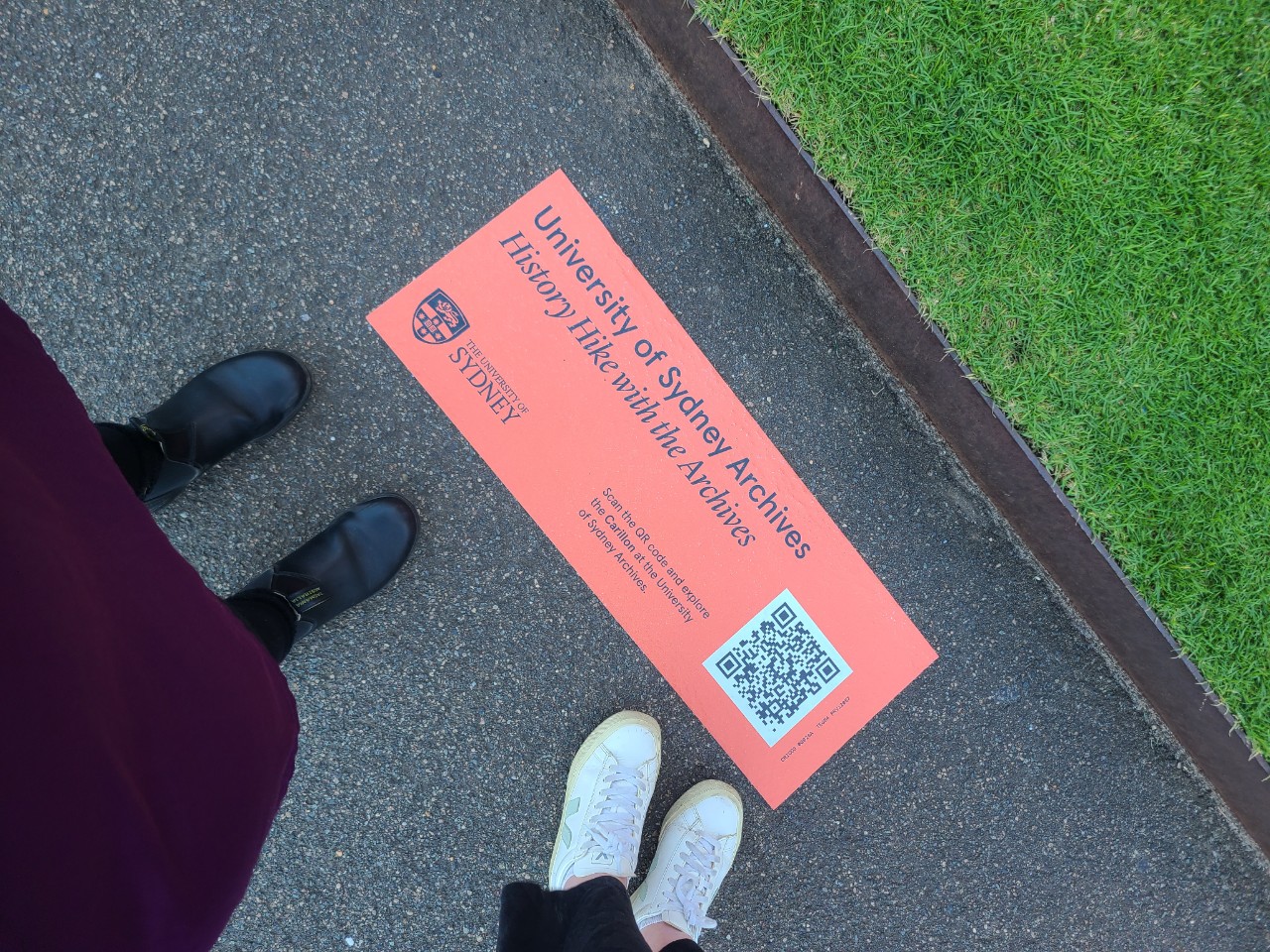People standing above a History Hike with the Archives orange decal on the ground.