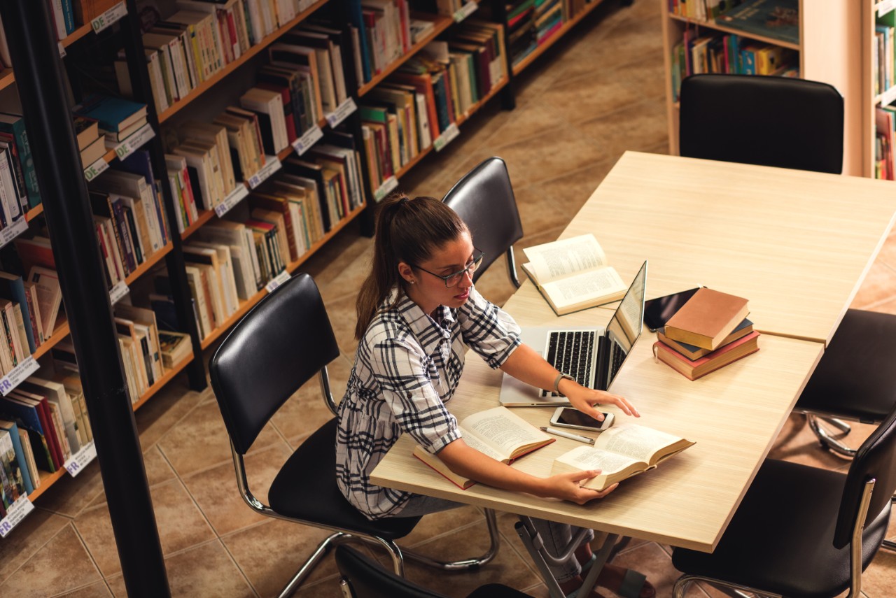 woman researching in a library
