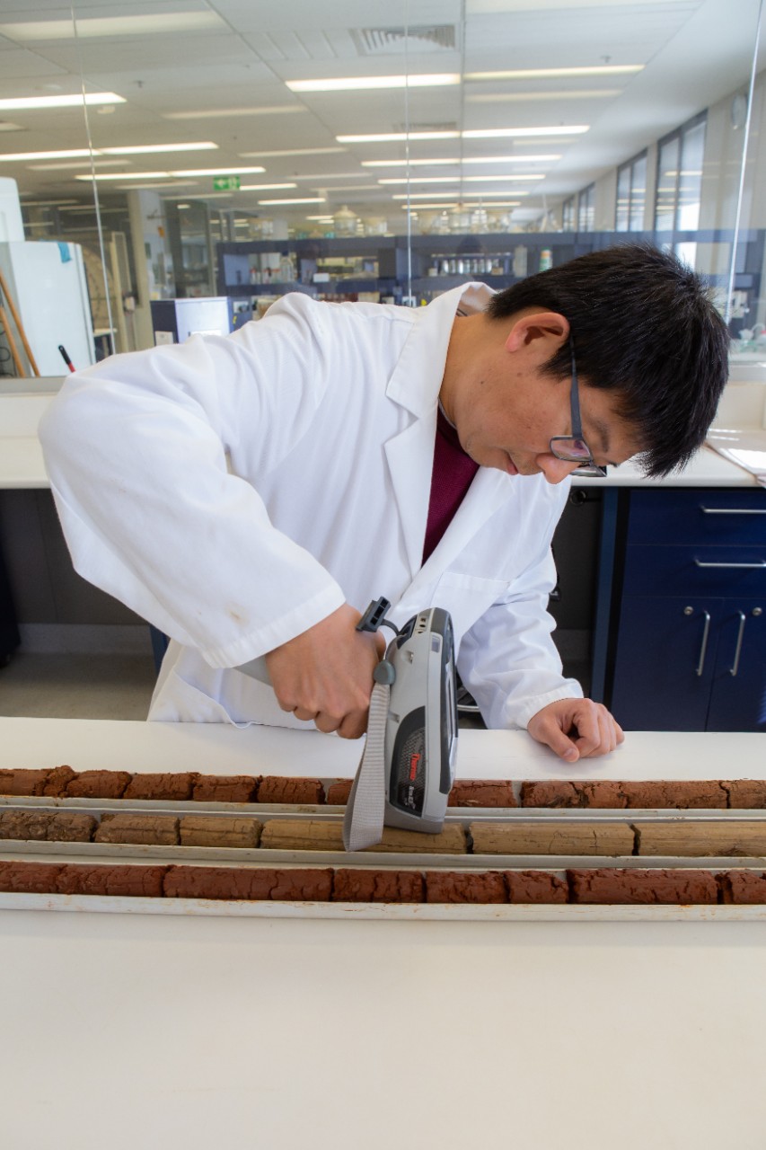 Professor Budiman Minasny inspecting soil
