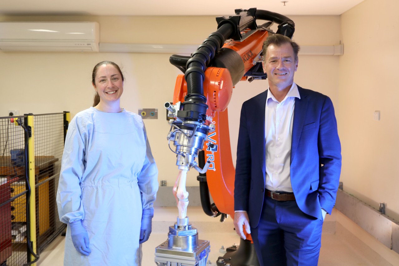 associate professor elizabeth clarke and professor bill walter standing in front of the robot