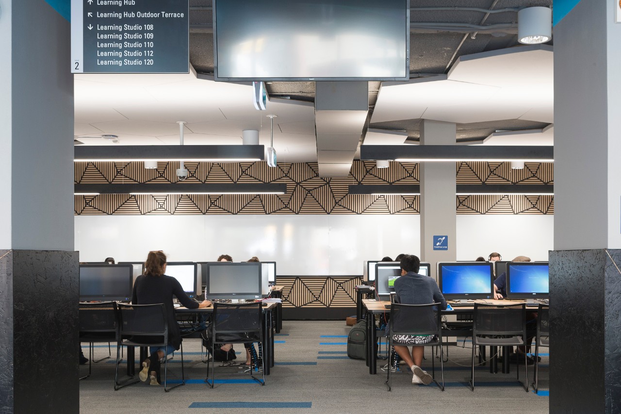 People sitting at computers in the Brennan McCallum Learning Hub.