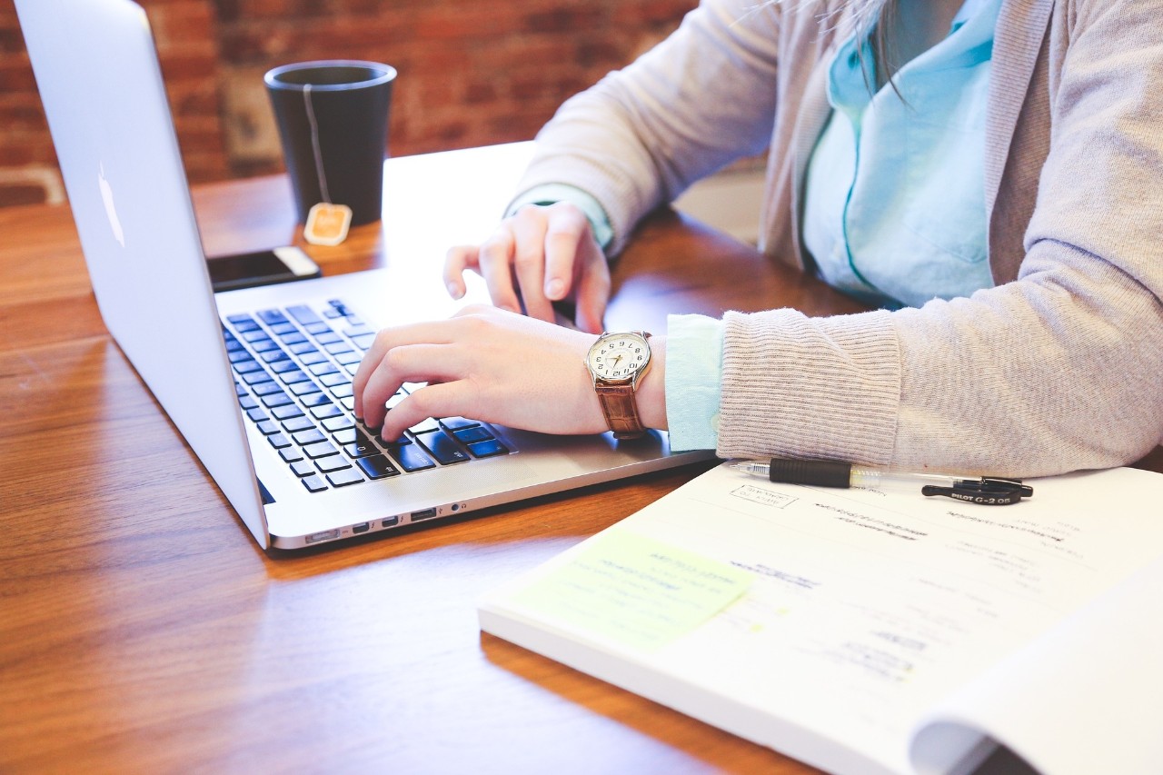 A close up shot of a female typing on a laptop. 