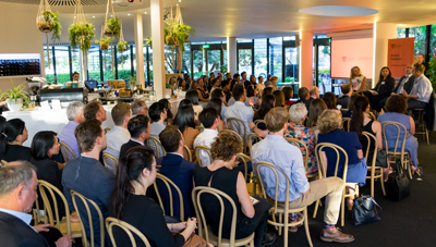 People sit in rows listening to a talk
