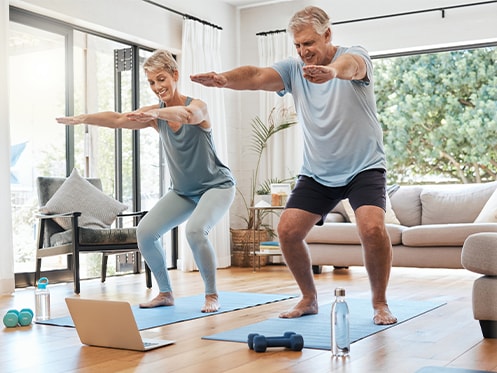 two people exercising in living room
