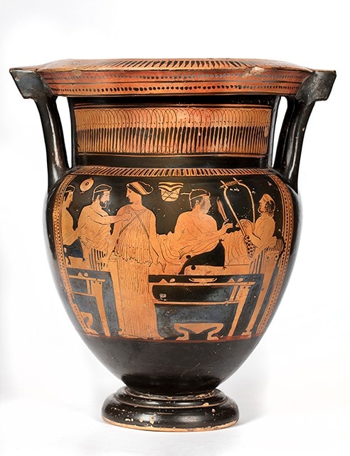An Athenian red figure column krater with symposium scene