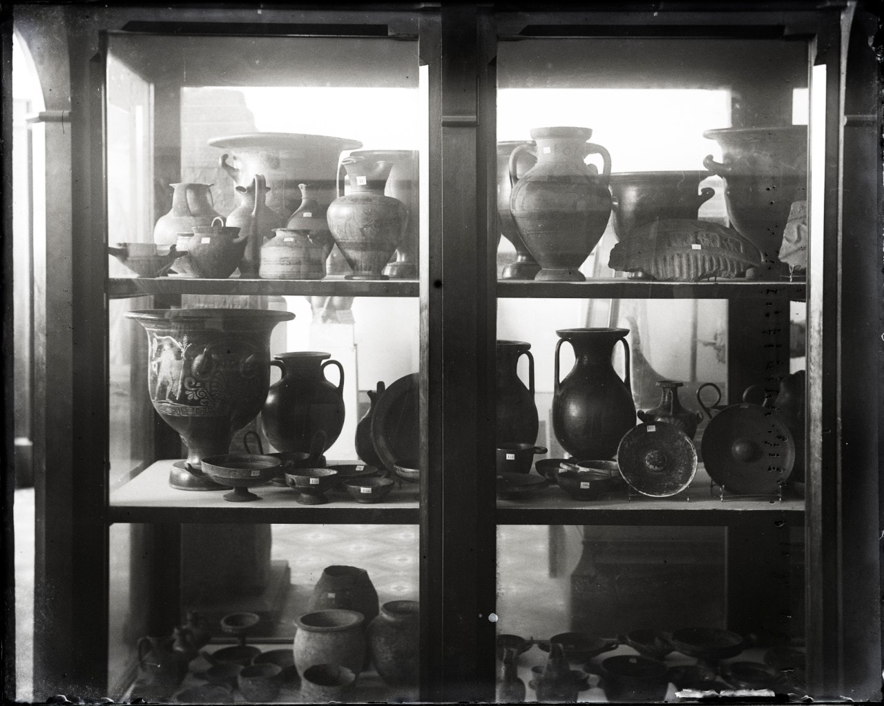 A cabinet filled with pottery.
