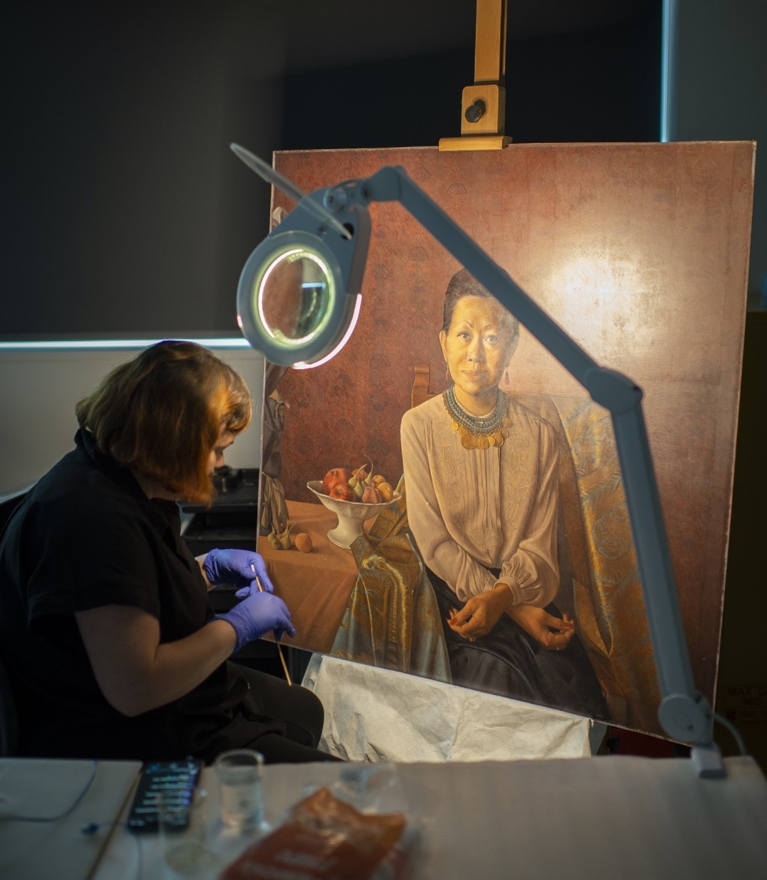Painting undergoing a light treatment by our conservator Siliva da Rocha