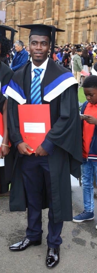 Social Work graduate, Murray Kamara, standing outside the Quad on his graduation day.