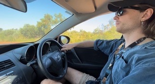 Calum Taylor driving through remote Australia