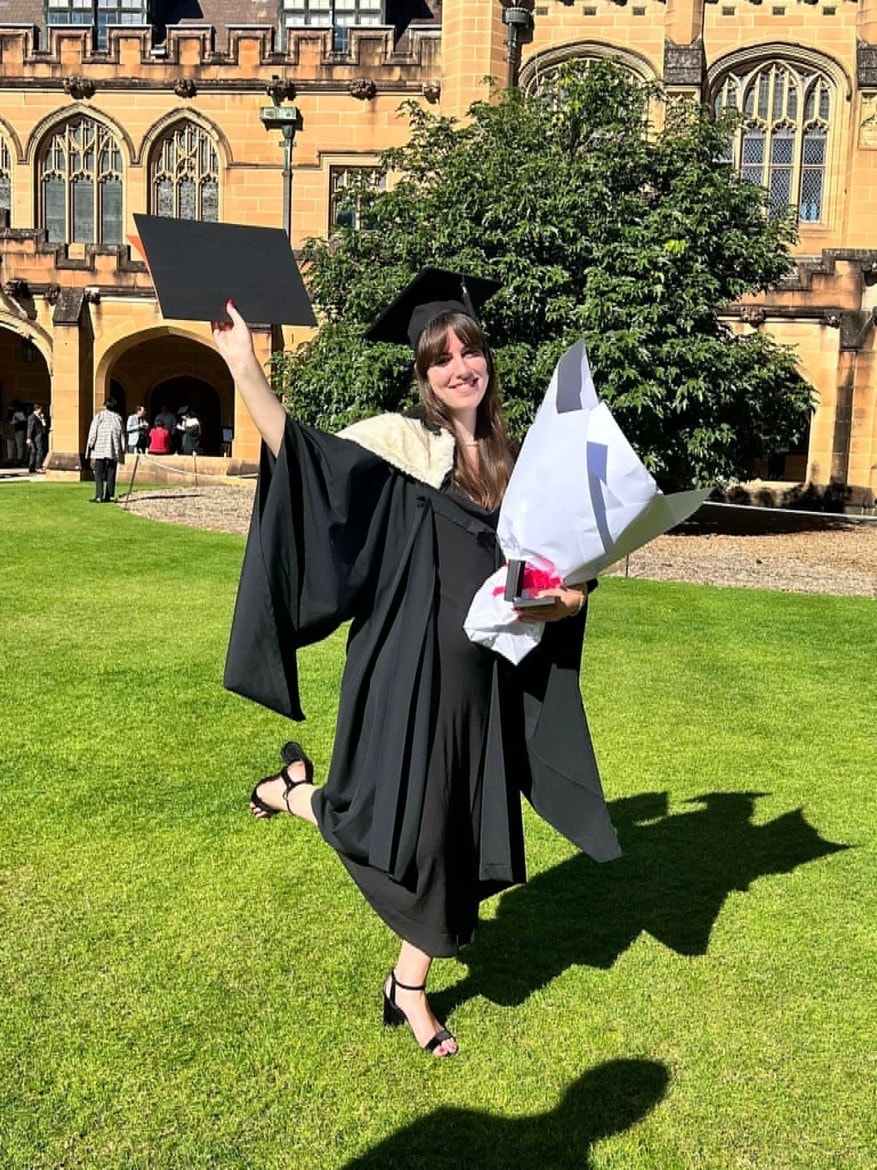 Freya Bruce-Gilchrist in her graduation gown outside the Great Hall