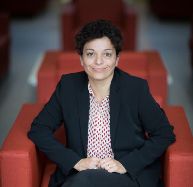Professor Céline Boehm, Head of School (Physics) sitting on a red armchair
