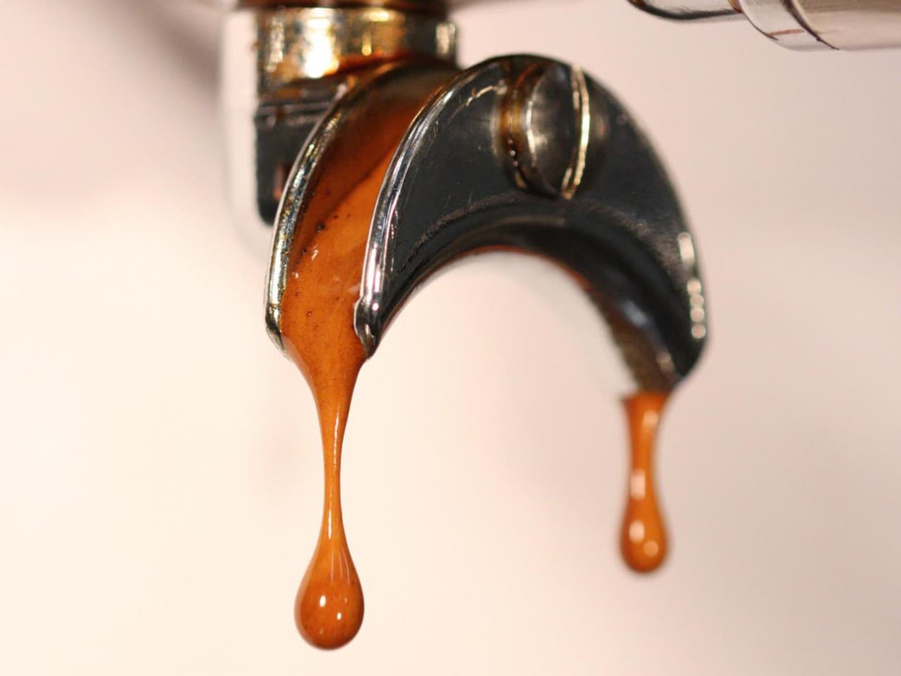 Close up coffee machine dripping coffee