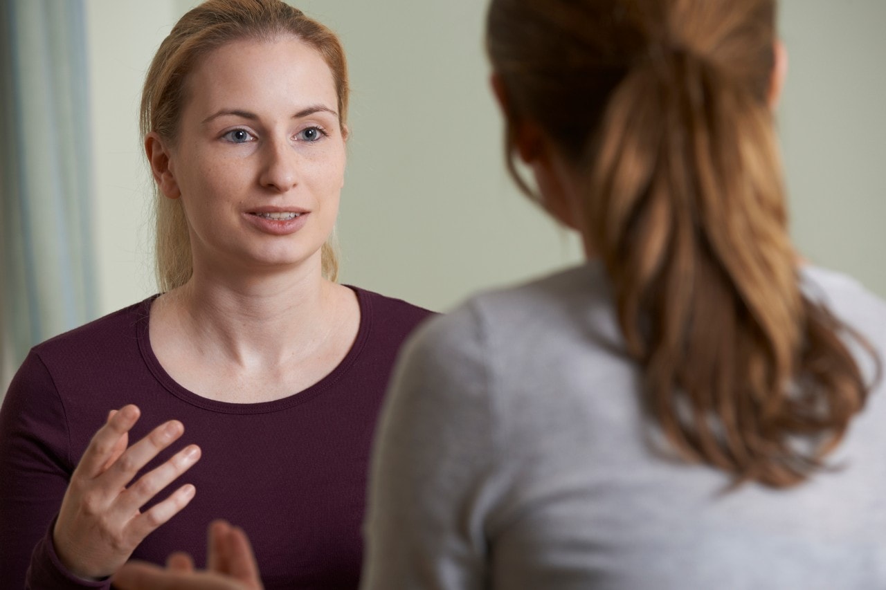 A psychologist speaks to a patient