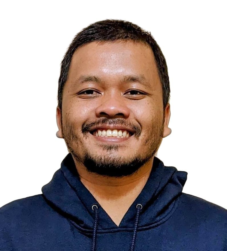 Diaz Prasetyo is wearing a dark blue hoodie and has short, dark hair and a short beard. He is smiling.