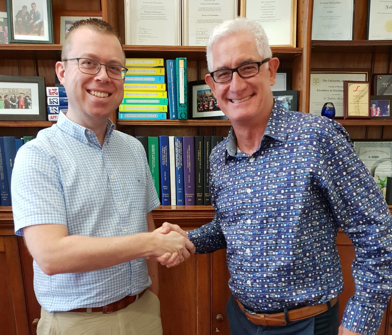 Professor Jan-Willem Alffenaar shaking hands with Professor Andrew McLachlan AM (R)