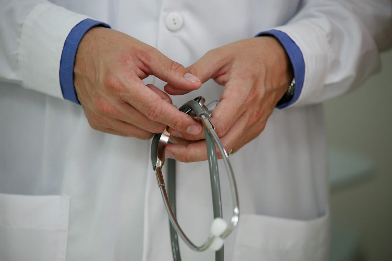 A doctor's hands holding a stethoscope