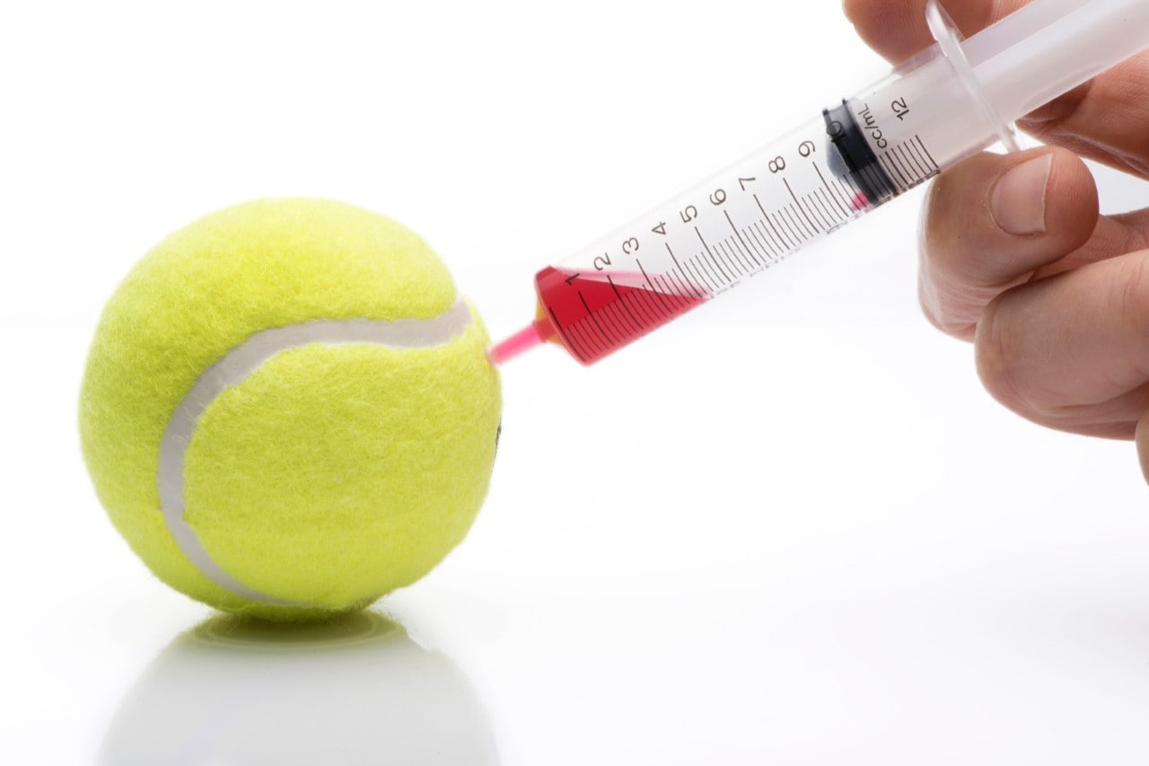 Tennis ball bring injected with needle 