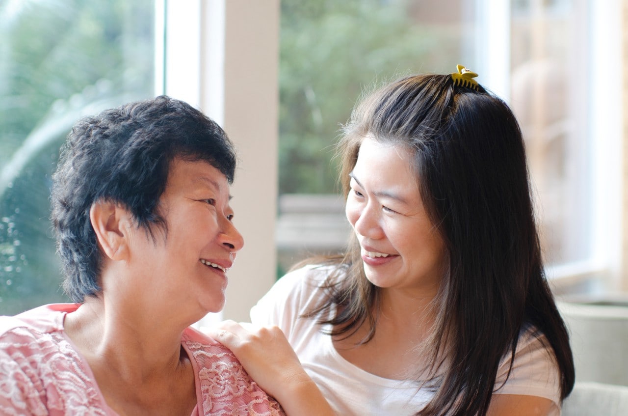 A stock image photograph of a mother and daughter in an embrace. 