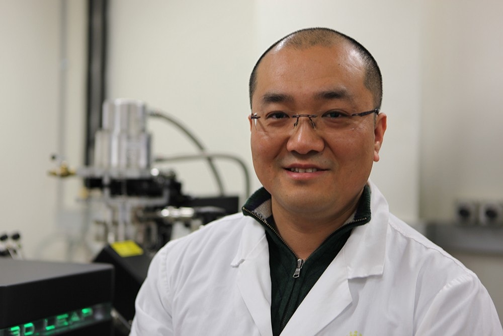 Jiangtao Qu standing in his lab.