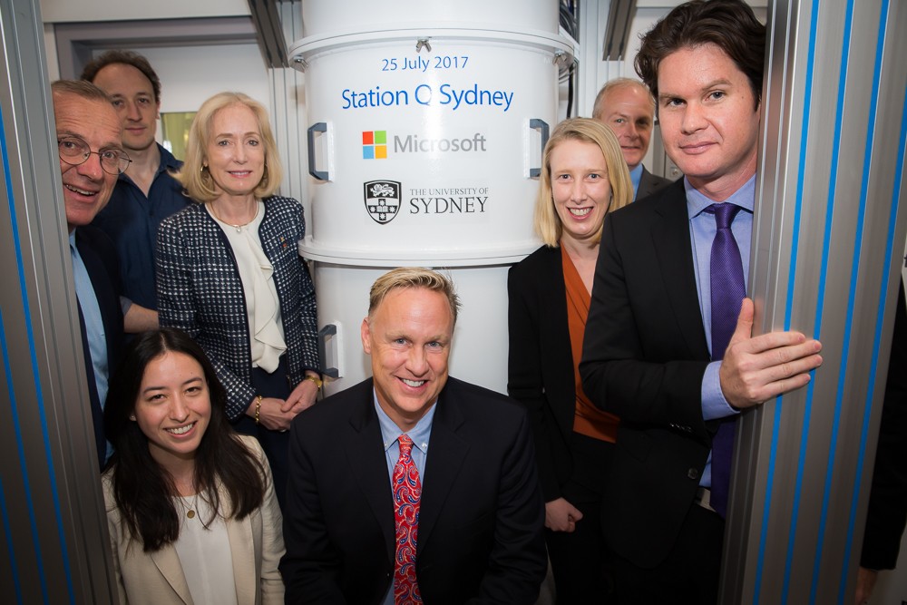 In front of one of the new specialist dilution refrigerators before the ceremonial signing.  Front row: PhD candidate Alice Mahoney with Microsoft’s Chief of Staff, Artificial Intelligence and Research Group Mr David Pritchard. Back row (R-L): Station Q Sydney Scientific  director Professor David Reilly; partner architect of Microsoft’s Quantum Architectures and Computation (QuArC) group Mr Douglas Carmean; Station Q Sydney senior research scientist Dr Maja Cassidy; University of Sydney Chancellor Belinda Hutchinson, Station Q Sydney postdoctoral researcher Dr John Hornibrook and University of Sydney Vice-Chancellor and Principal Dr Michael Spence. Credit: Jayne Ion.