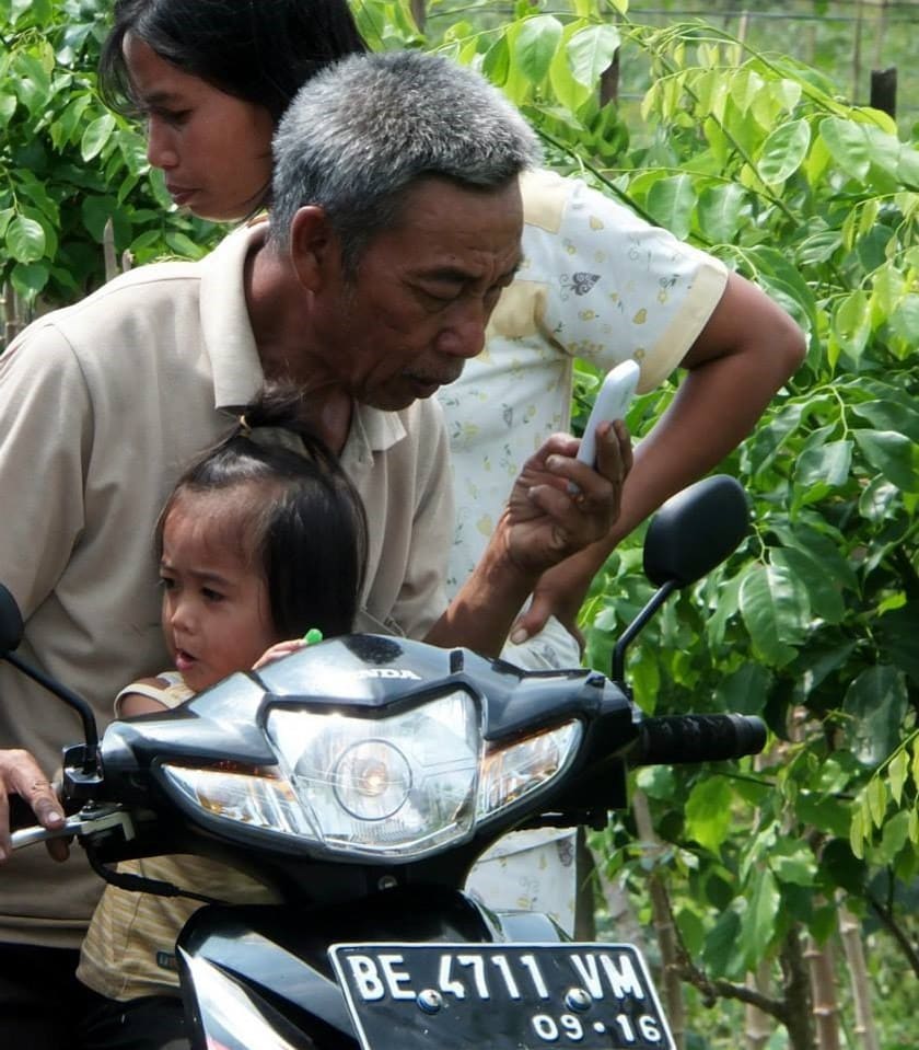 A mobile phone user on a motorbike in Sumatra, Indonesia. Photo: Petr Matous.