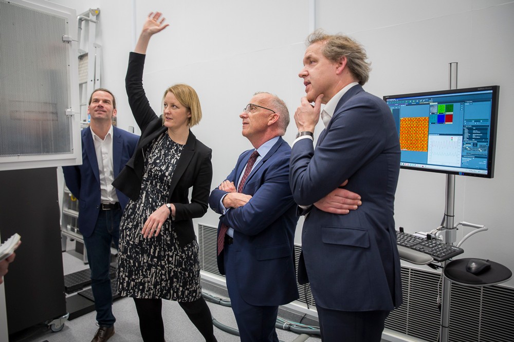 Professor Julie Cairney explains how the microscope works to Vice-Chancellor Dr Michael Spence (second from right) and Deputy Vice-Chancellor (Research) Professor Duncan Ivision (right). With them is Dr Magnus Garbrecht, who operates the TEM. Photo by Jayne Ion