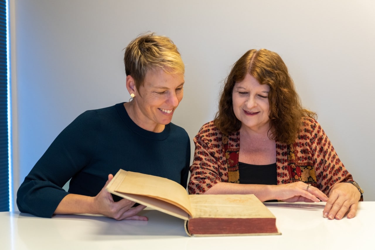 Julie Sommerfeldt and Kim Wilson with the 1497 book.