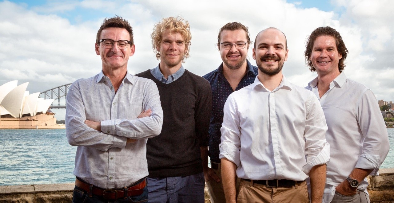 Photo of five scientists in front of the Sydney Opera House