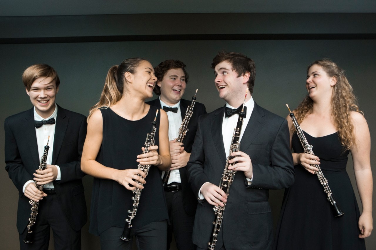 Photo of a group of musicians smiling and laughing