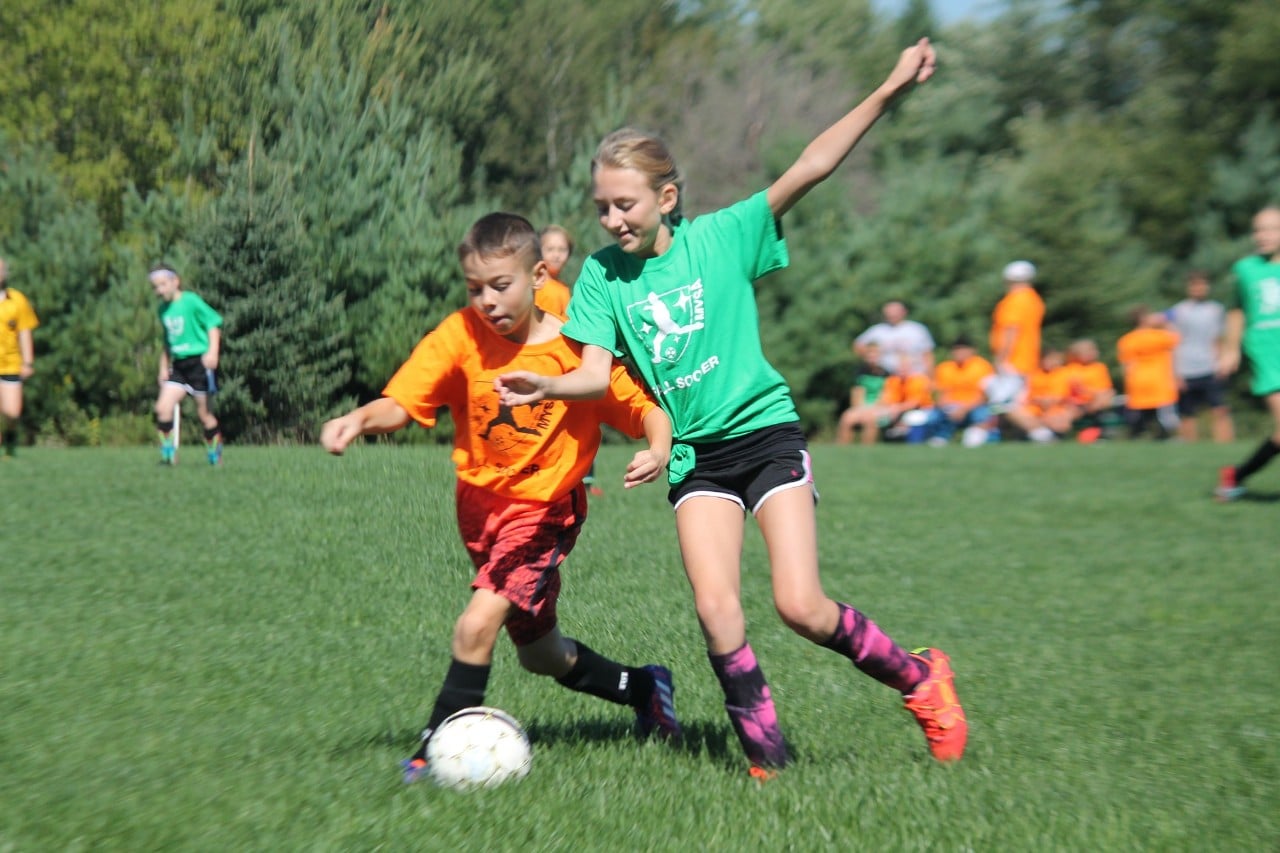 photo of a boy and girl playing soccer