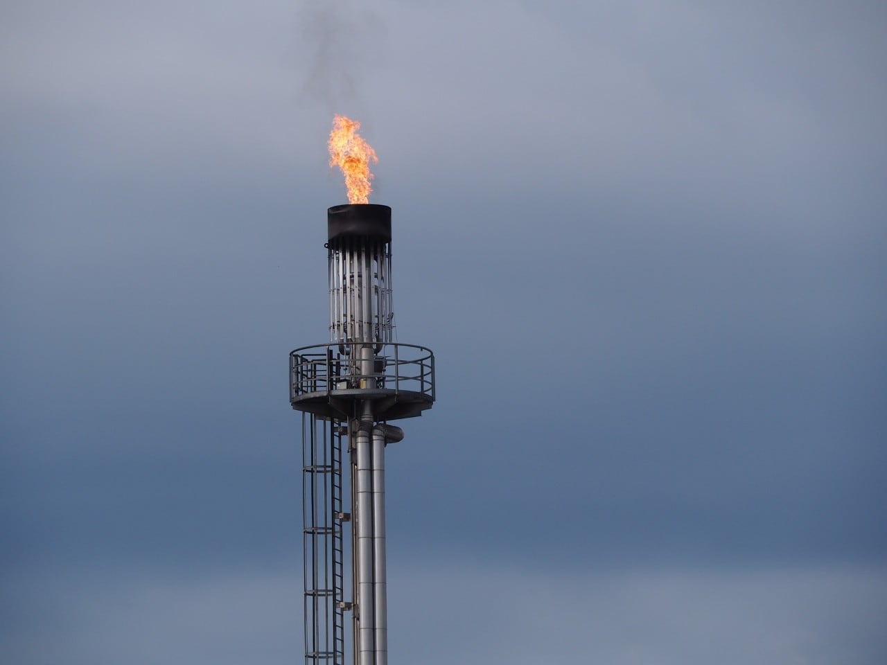 Photo of a gas flame coming from an oil rig tower