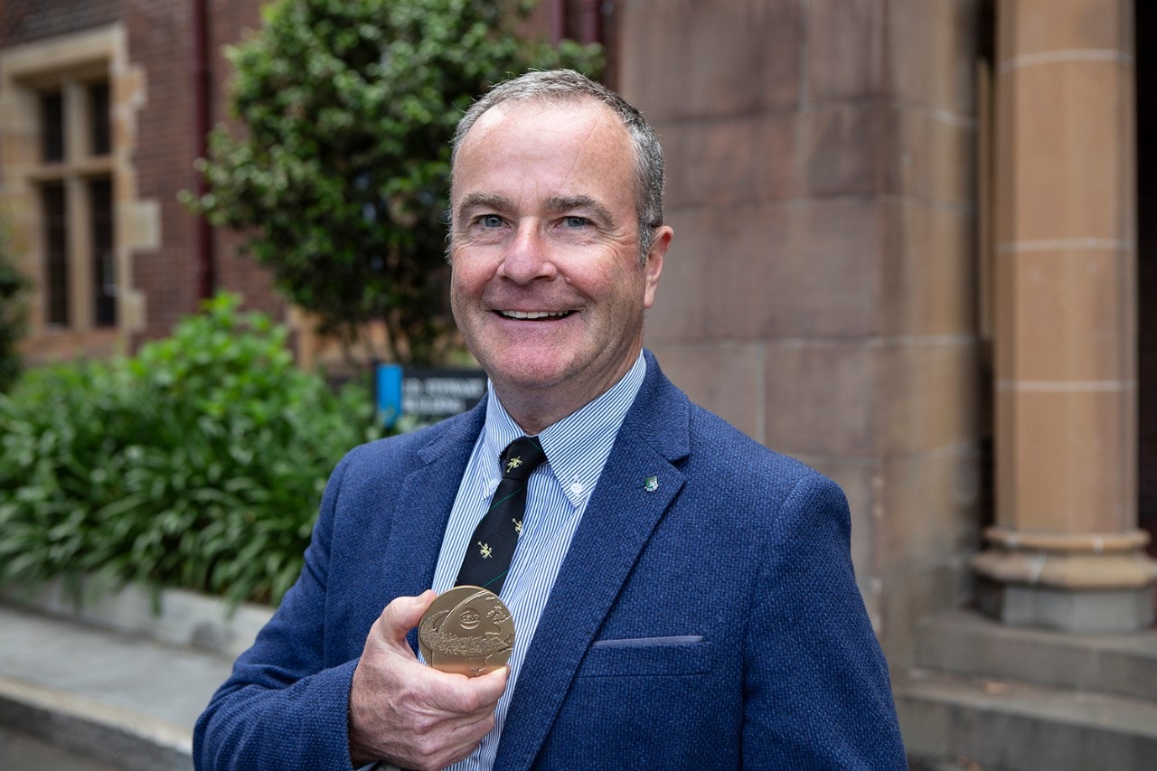 photo of Professor Paul McGreevy holding his medal