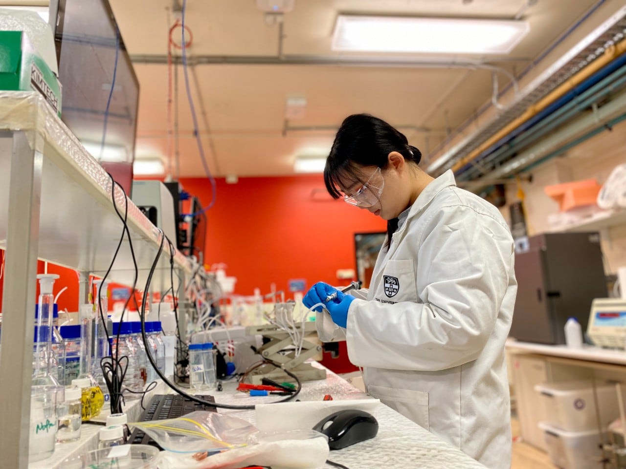 PhD candidate, Ms Shuzhen Zhang, who contributed to this project, samples the outlet stream from the electrochemical reactor for product analysis.