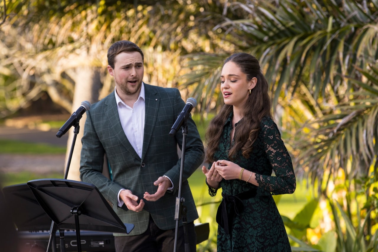 two opera singers performing outdoors