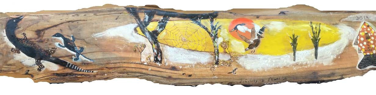 Long wooden artwork featuring goannas, ducks and bass of different sizes and a large spider web etched into the background