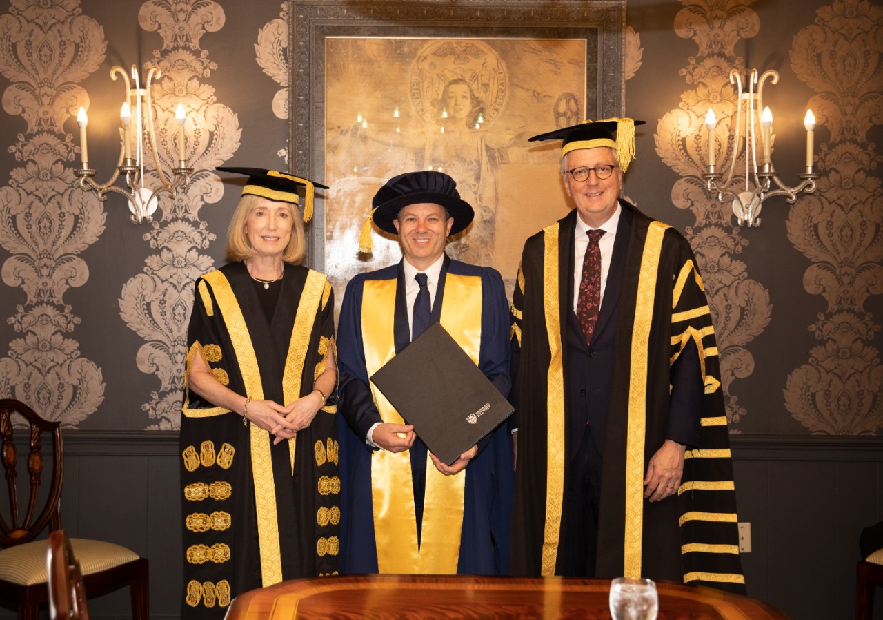 Image of three people in university gowns