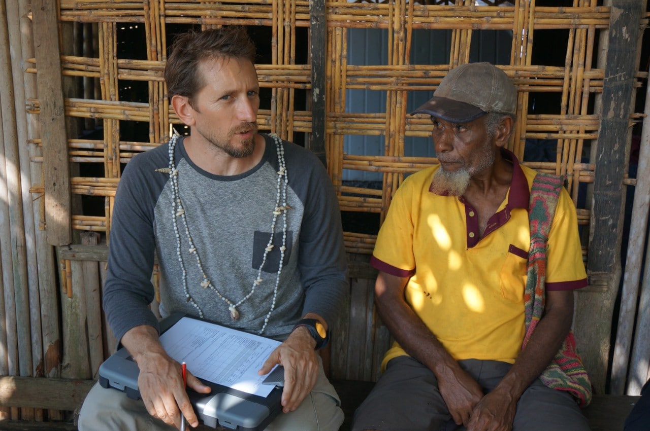 Professor Josh Cinner discussing study results with a clan chief in Muluk village, Karkar Island, Papua New Guinea.