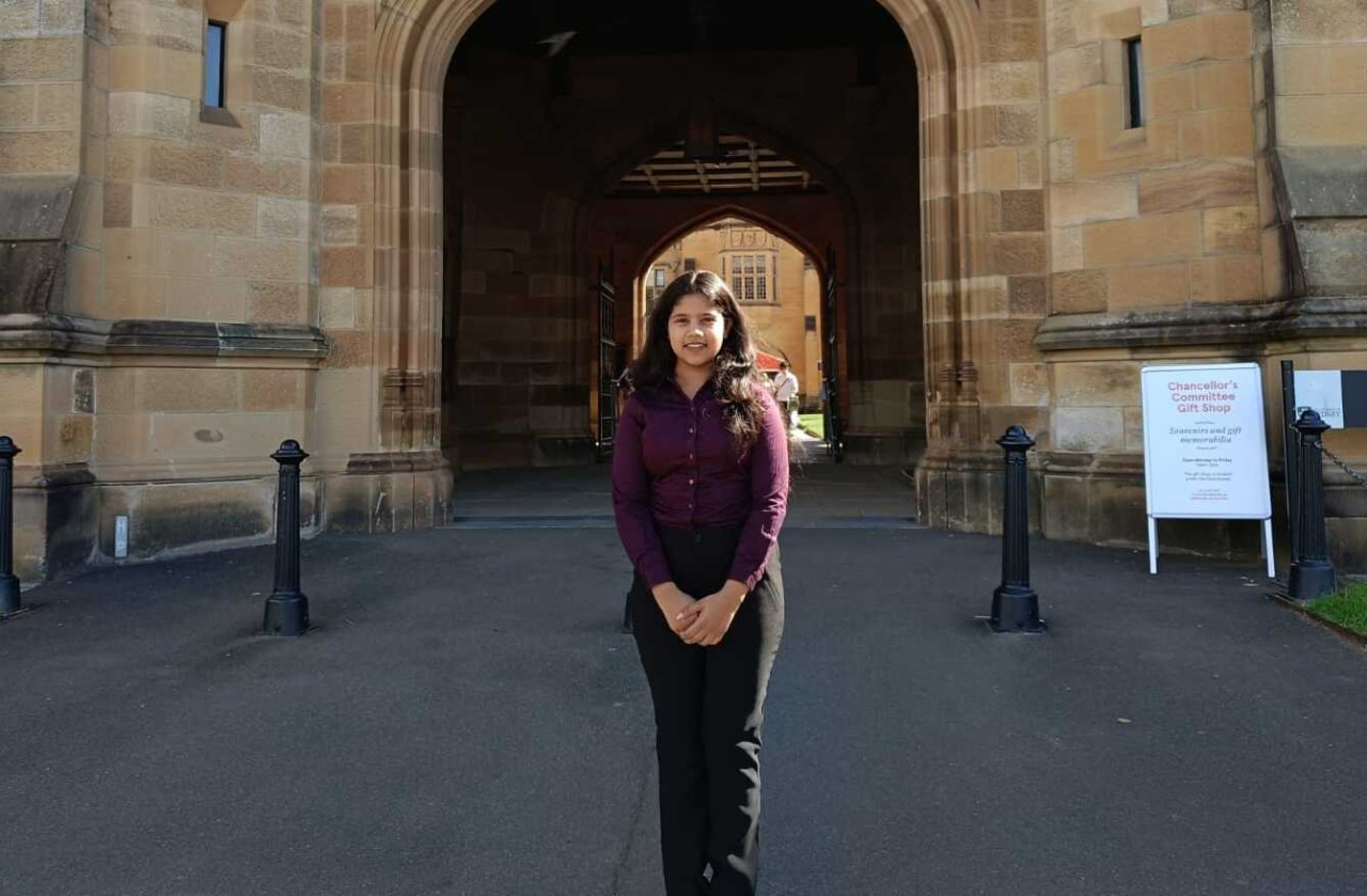 Female student standing in front of a University building. 