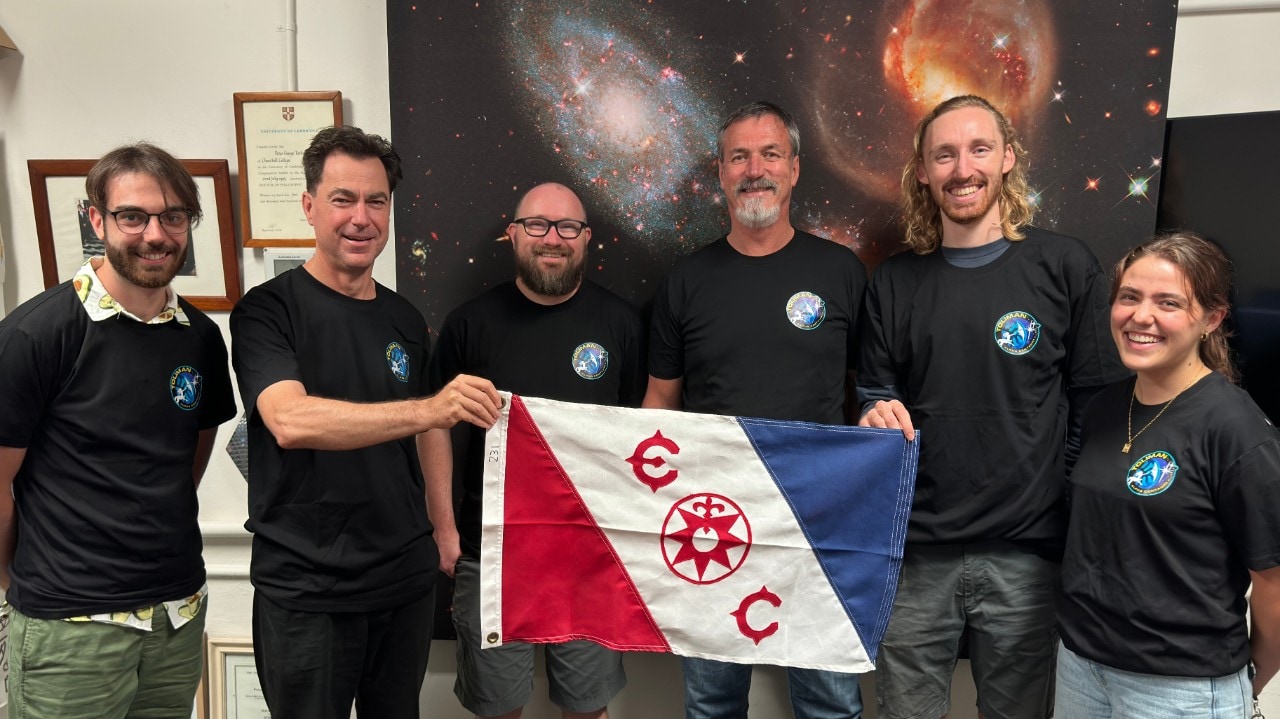 Professor Peter Tuthill and team with the Explorers Club flag.