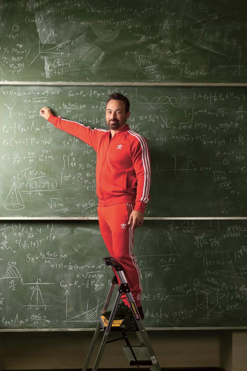 Derek writing equations on a chalkboard