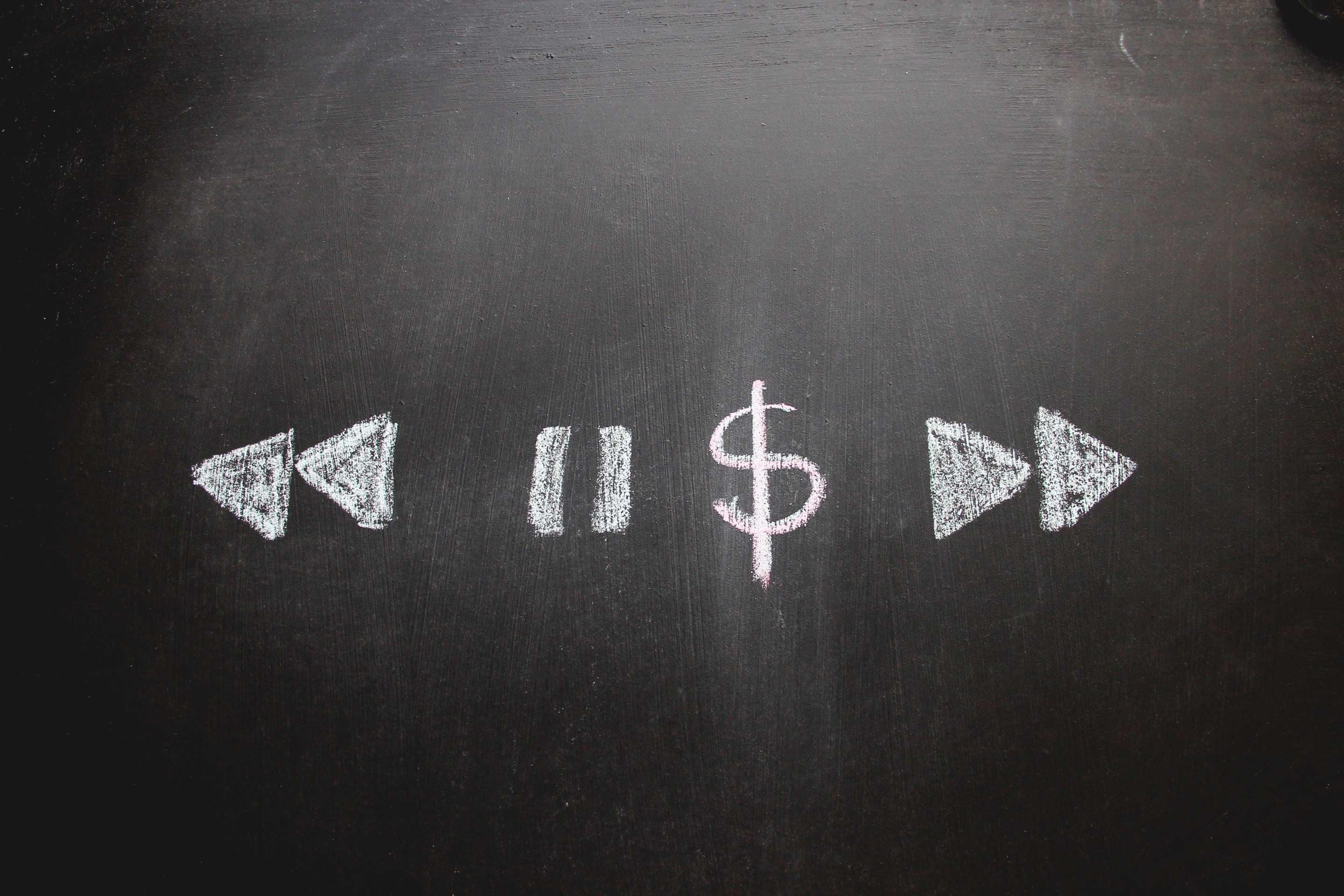 A dollar sign amongst pause, rewind and fast-forward signs. Image: iStock