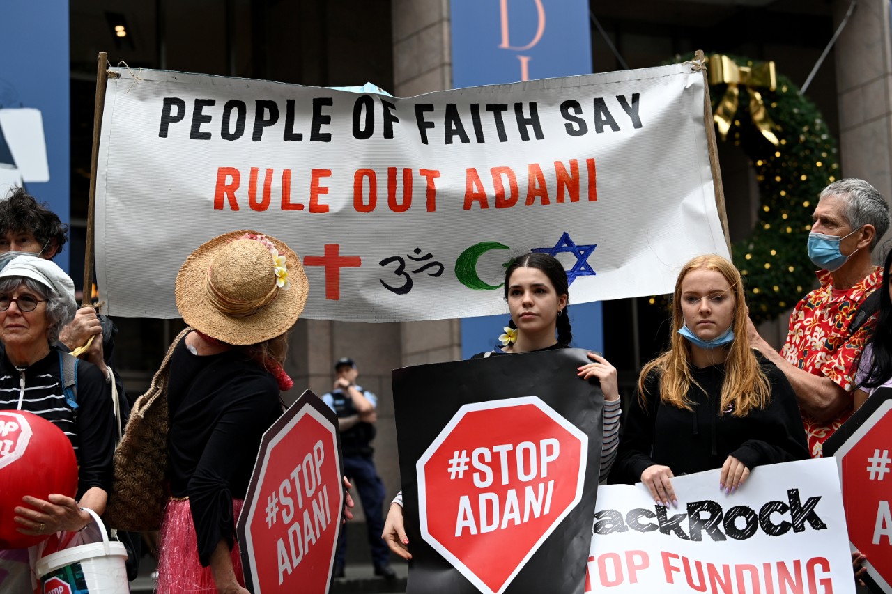 Stop Adani protestors holding signs.