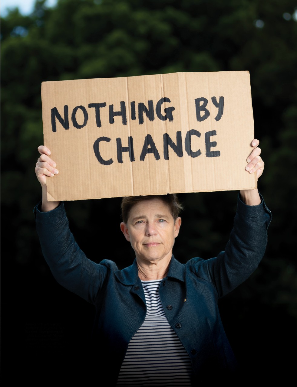 Rebecca Peters holding a placard saying 'nothing by chance'
