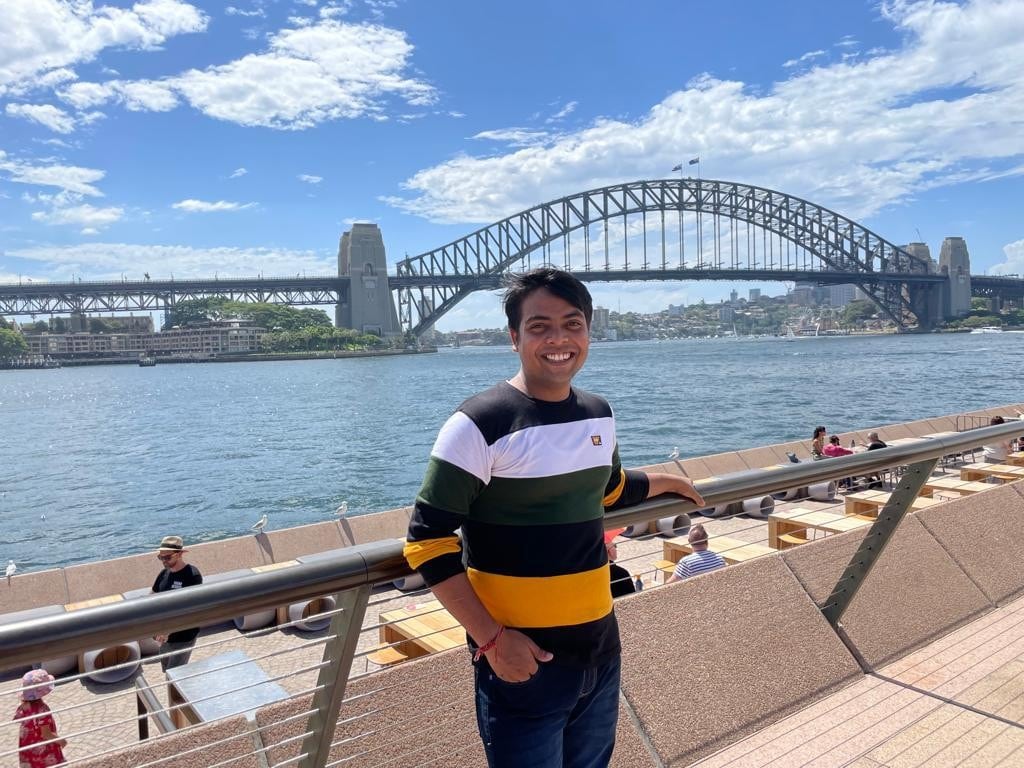 Tushar Joshi posing in front of the the Sydney Harbour Bridge