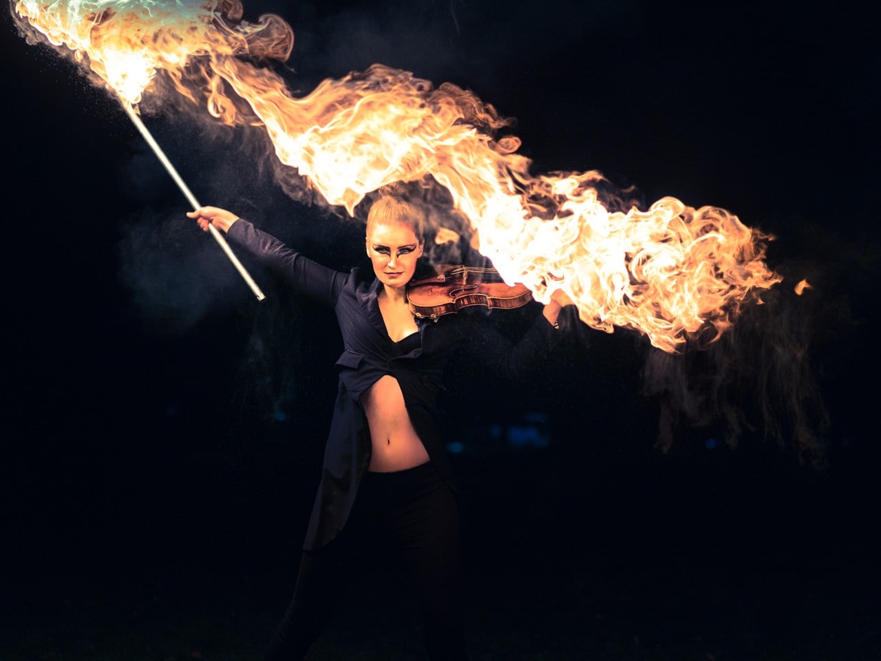 Female performing with violin and fire