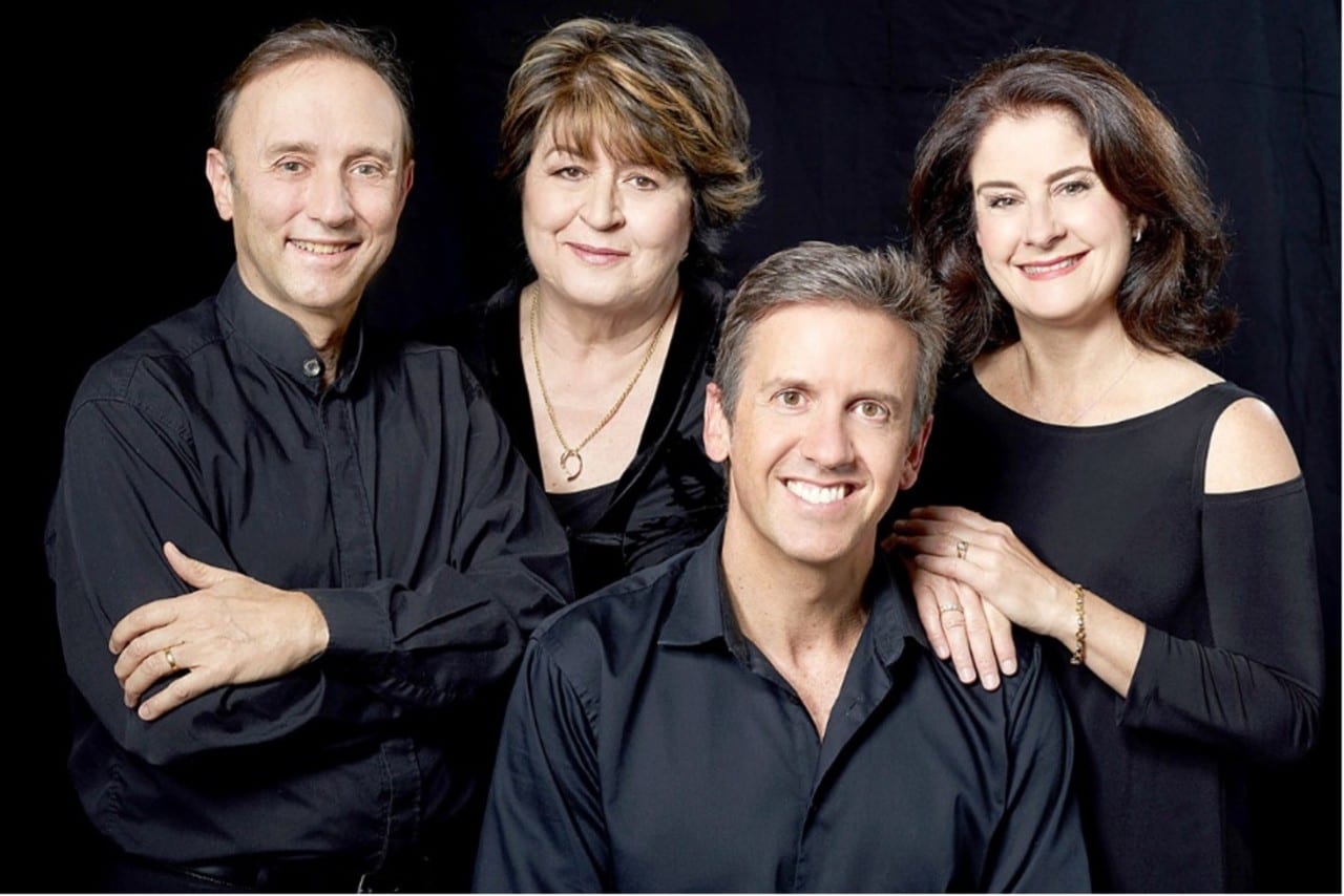 The Goldner String Quartet, four people in black clothes smiling at camera