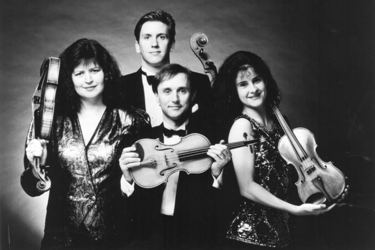 Goldner String Quartet in 1995. Four musicians holding their violins.