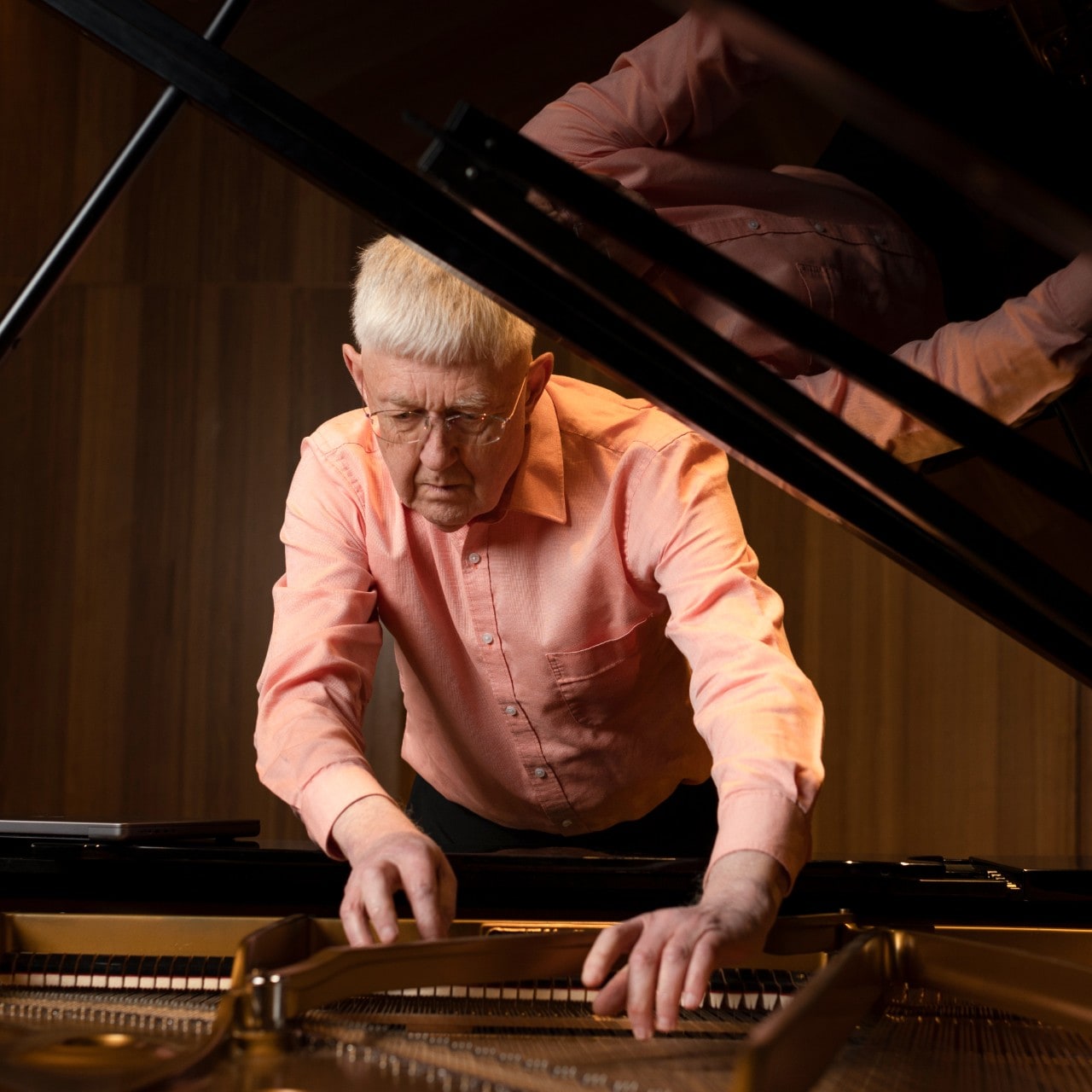 Professor Roger Dean examining a grand piano